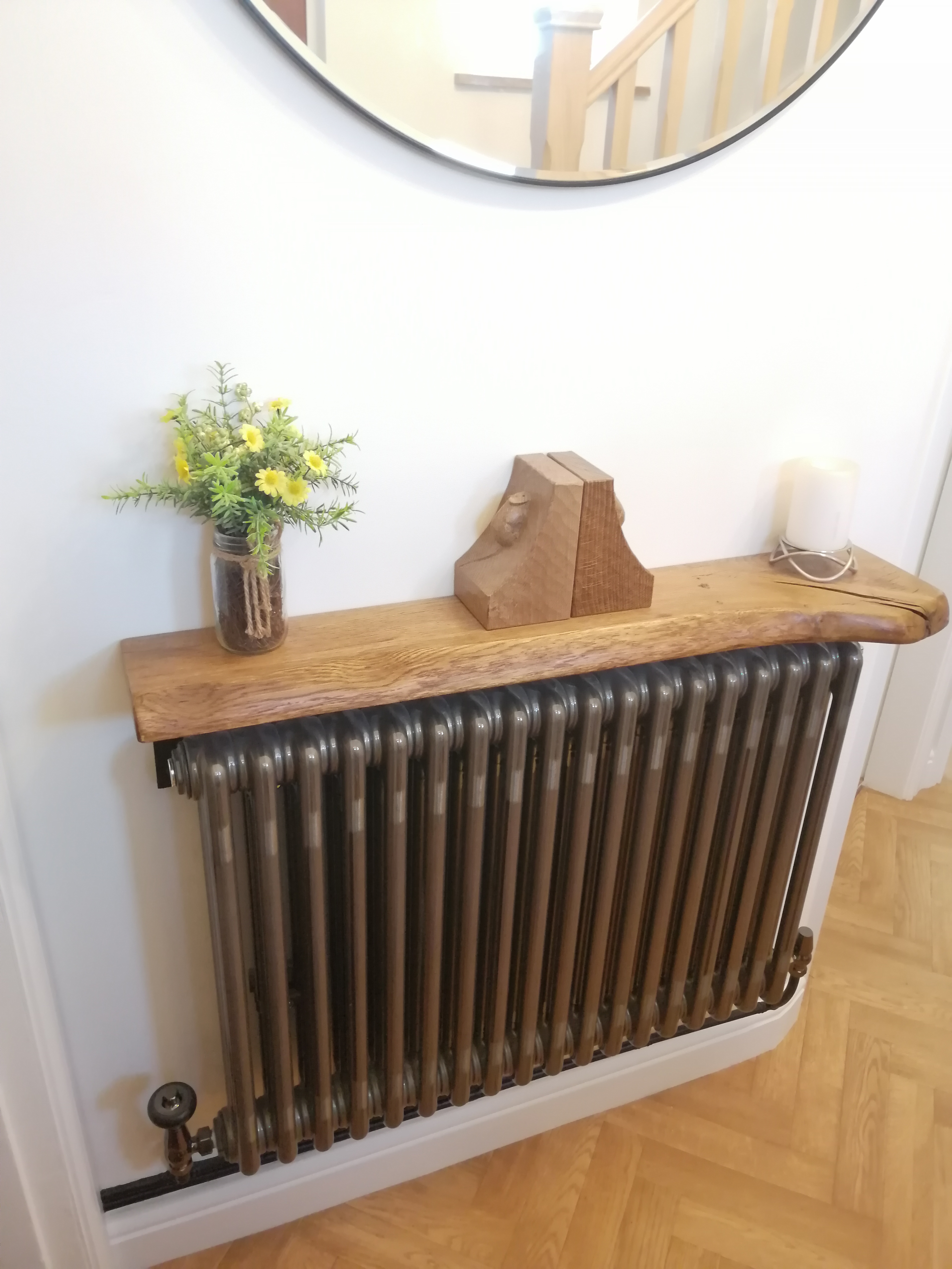 Oak windowsill and woodwork above a dark panelled radiator