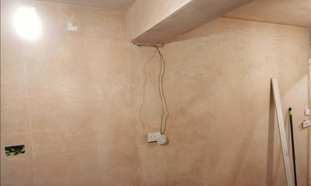 Interior wall with a newly plastered surface prepared for painting